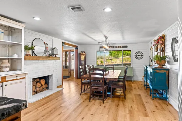a view of a kitchen with furniture and wooden floor