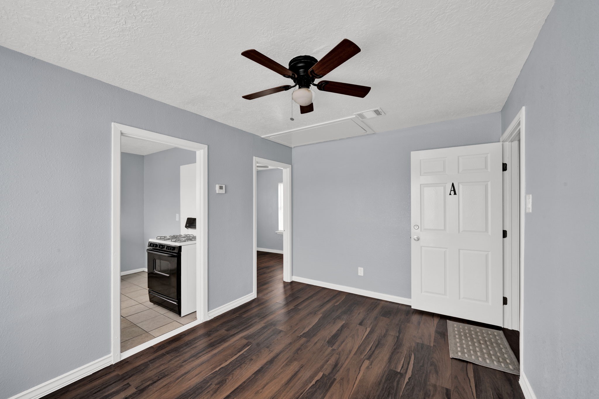 904 Beverly Avenue, Unit 6 Pasadena, TX 77506 - Photo 5 of 32 a view of cabinets with wooden floor and ceiling fan