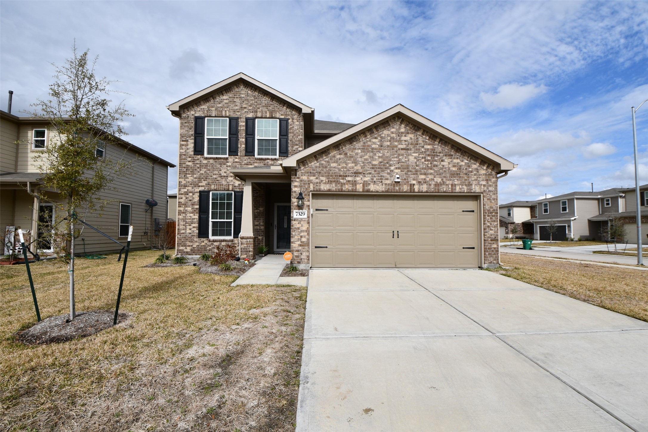 7329 Madison Commons Lane Houston, TX 77075 - Photo 1 of 22 a front view of a house with garden