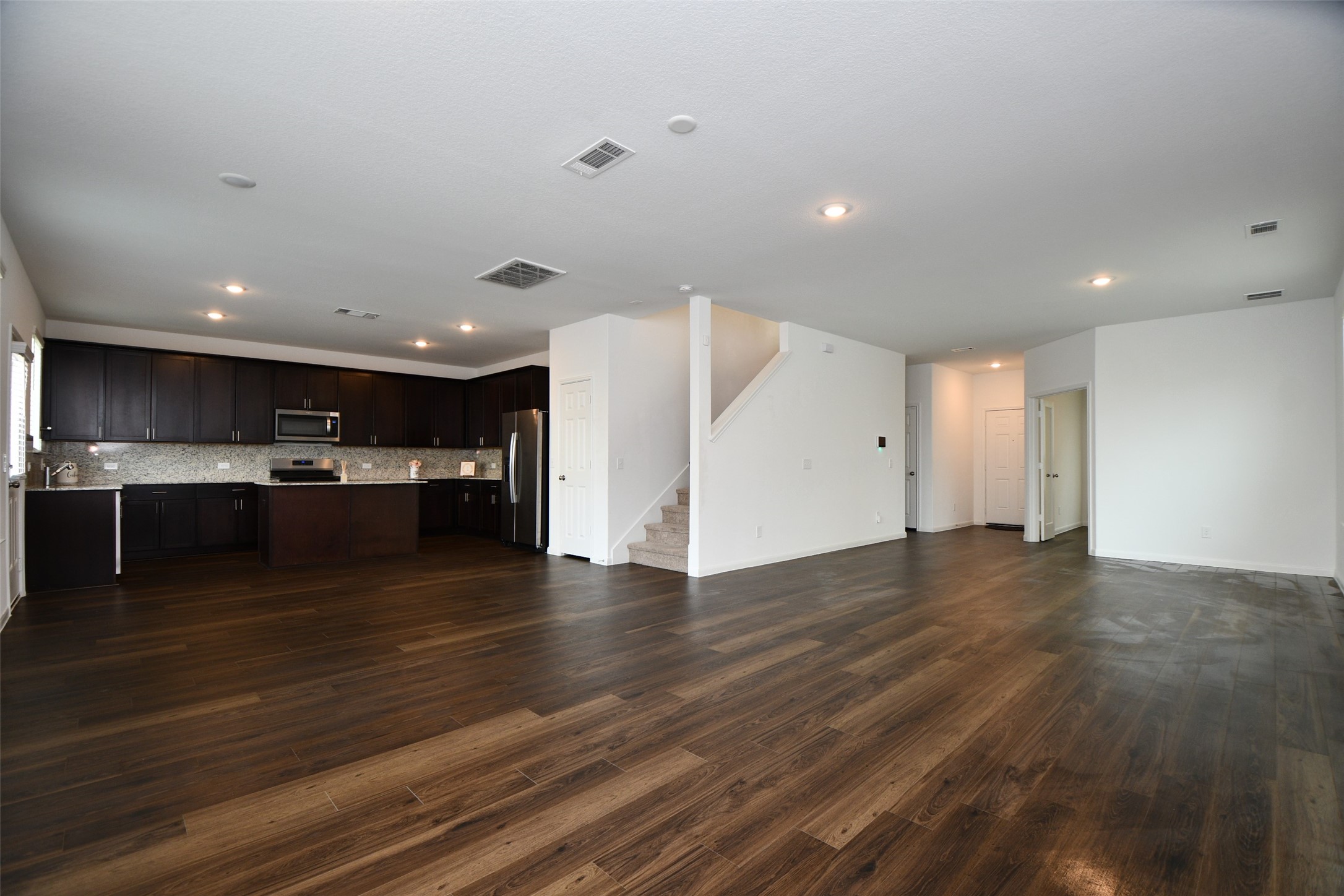 7329 Madison Commons Lane Houston, TX 77075 - Photo 8 of 22 a view of kitchen with kitchen island a sink wooden floor and a refrigerator