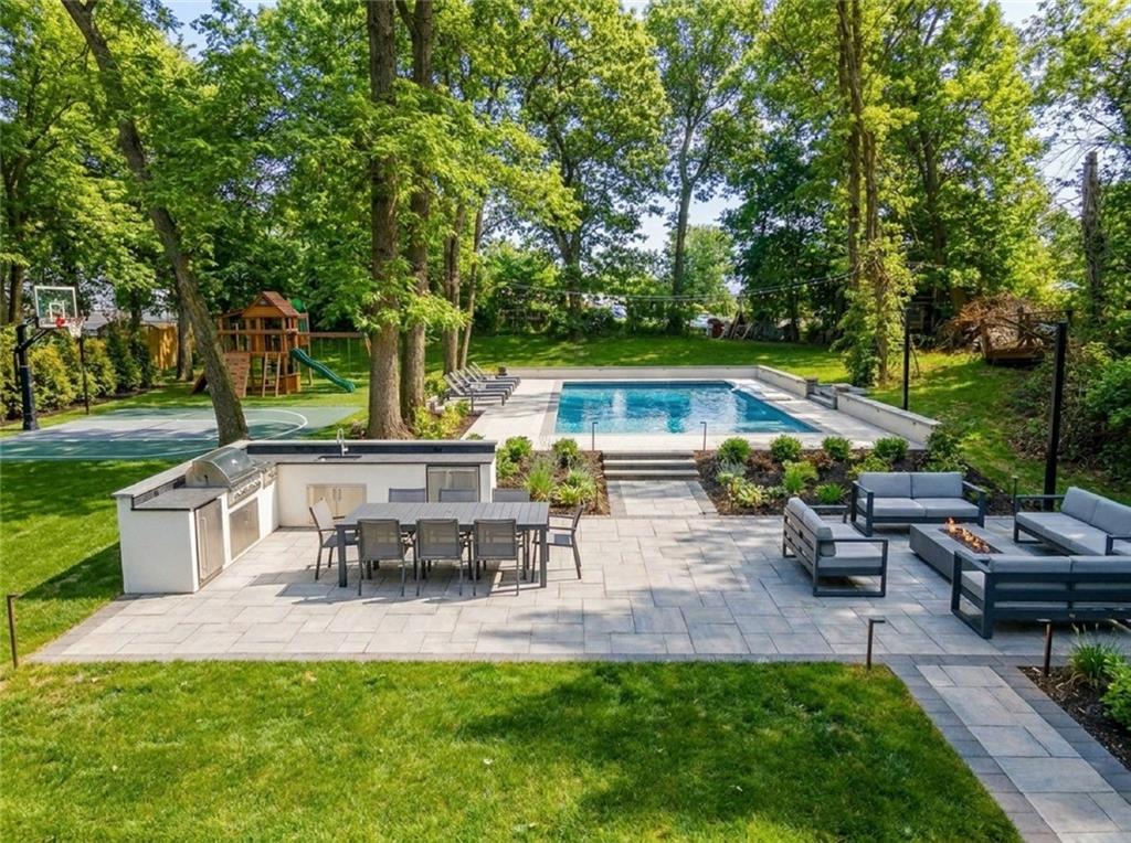 636 Holmdel Road Hazlet, NJ 07730 - Photo 42 of 47 a view of a patio with table and chairs potted plants and a large tree