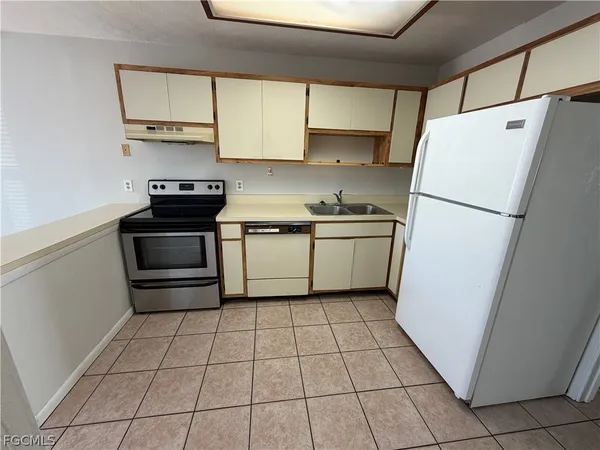 a kitchen with a stove a refrigerator and a sink
