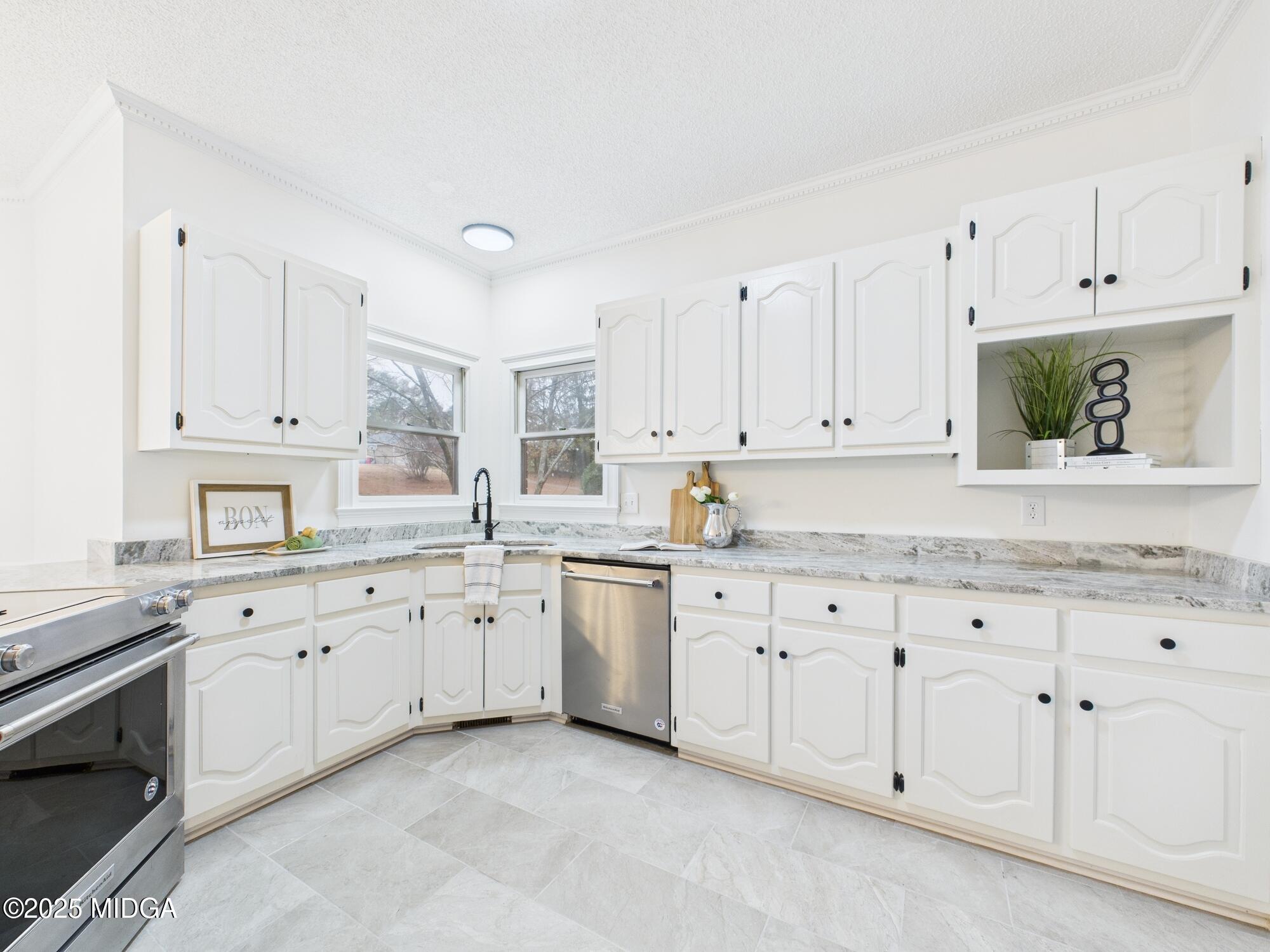 607 Chastain Place Macon, GA 31210 - Photo 12 of 63 a kitchen with granite countertop white cabinets white stainless steel appliances with a sink and dishwasher