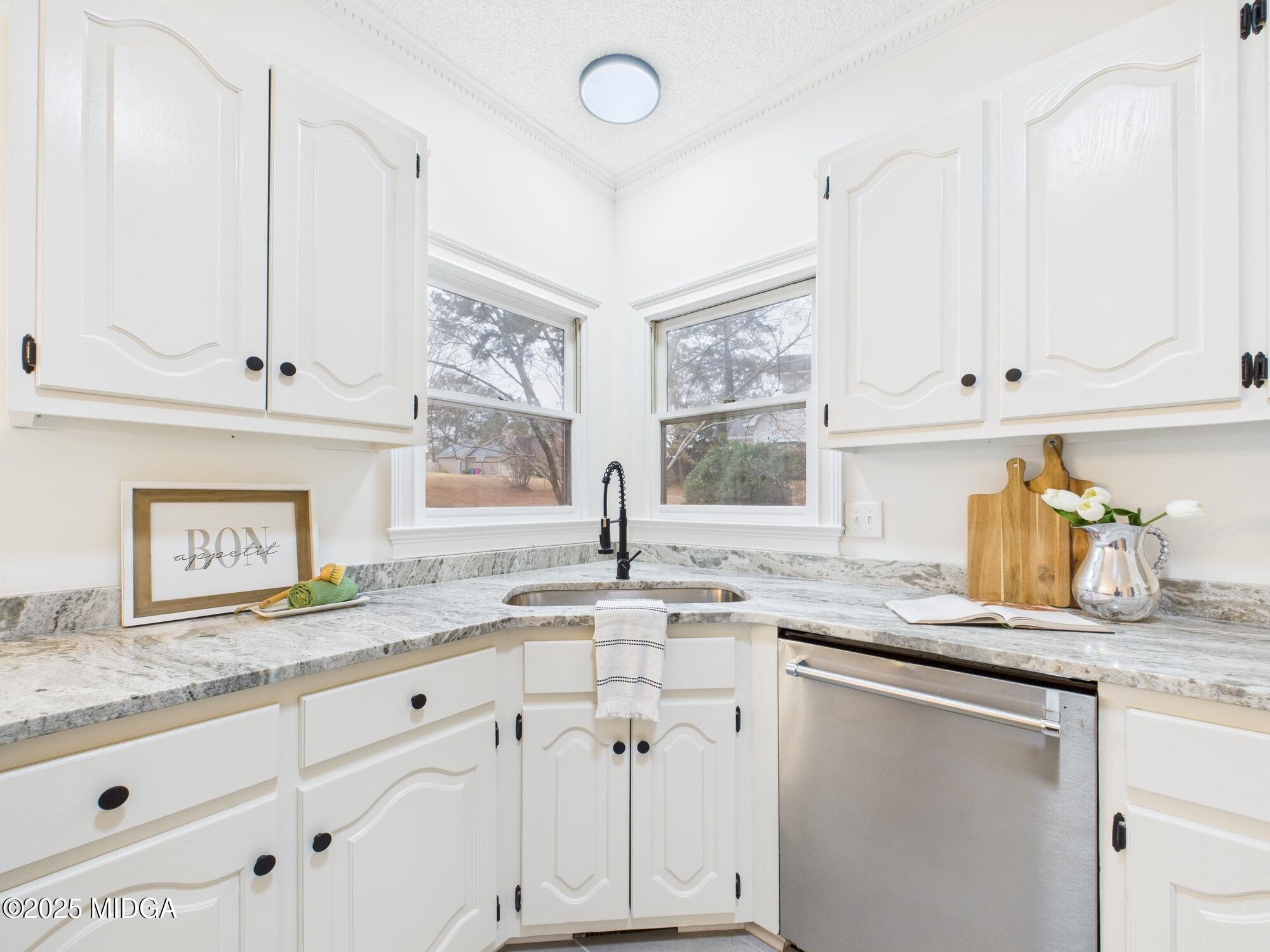 607 Chastain Place Macon, GA 31210 - Photo 13 of 63 a kitchen with granite countertop white cabinets and white appliances