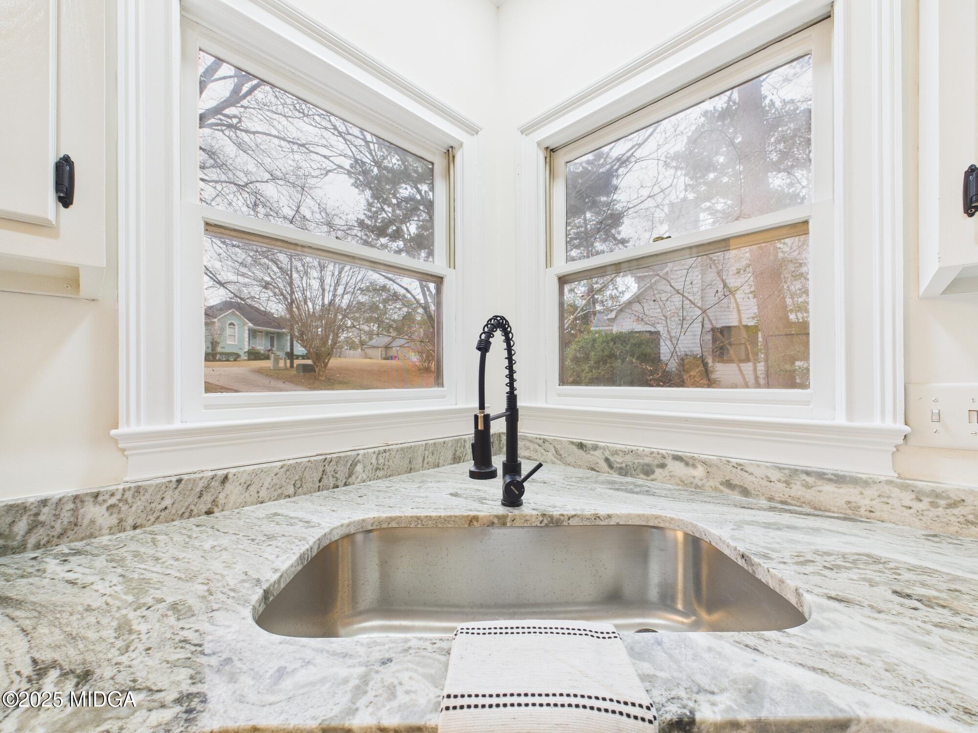 607 Chastain Place Macon, GA 31210 - Photo 14 of 63 a kitchen with granite countertop a sink and a window