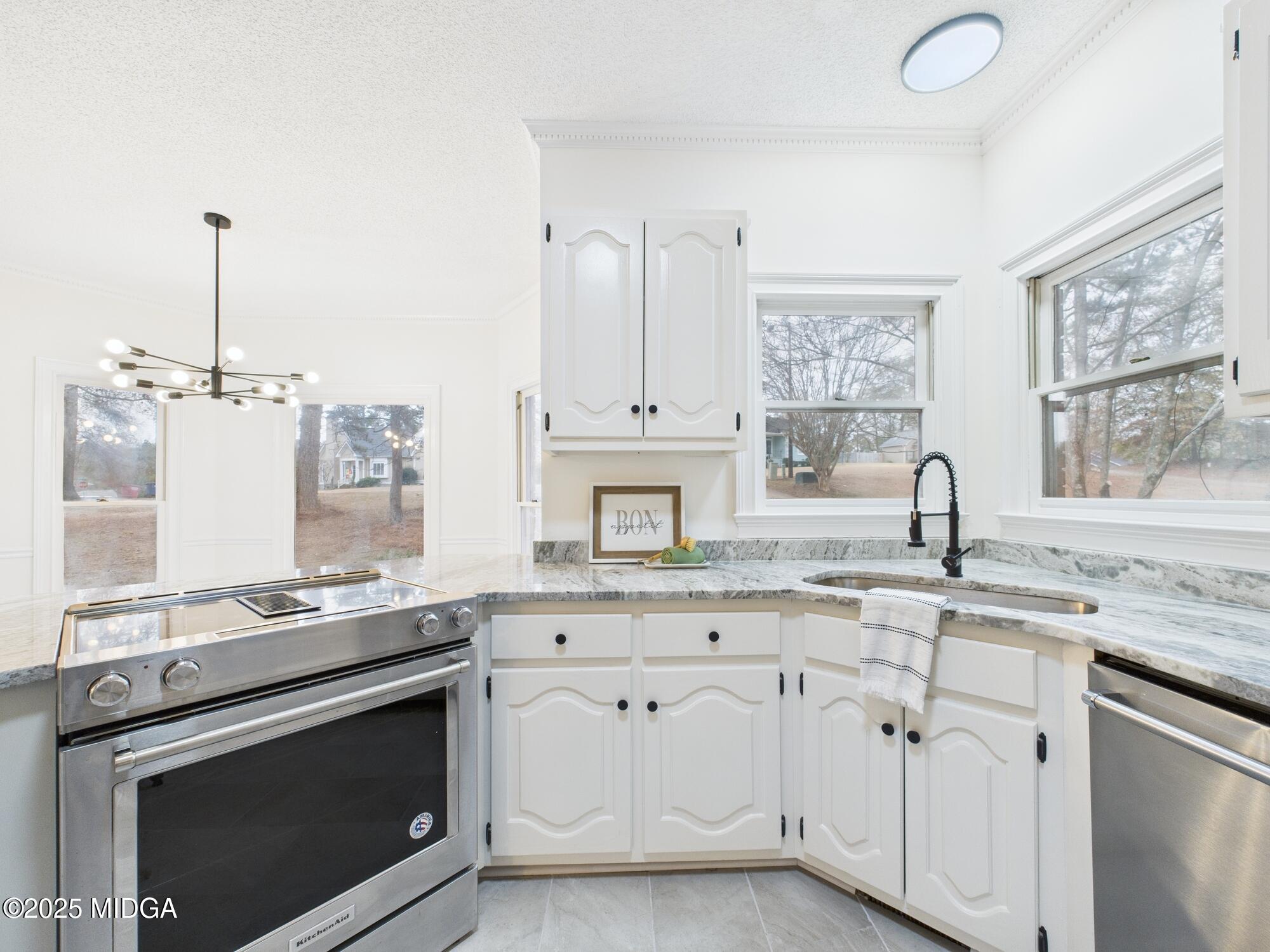 607 Chastain Place Macon, GA 31210 - Photo 15 of 63 a kitchen with granite countertop white cabinets and appliances