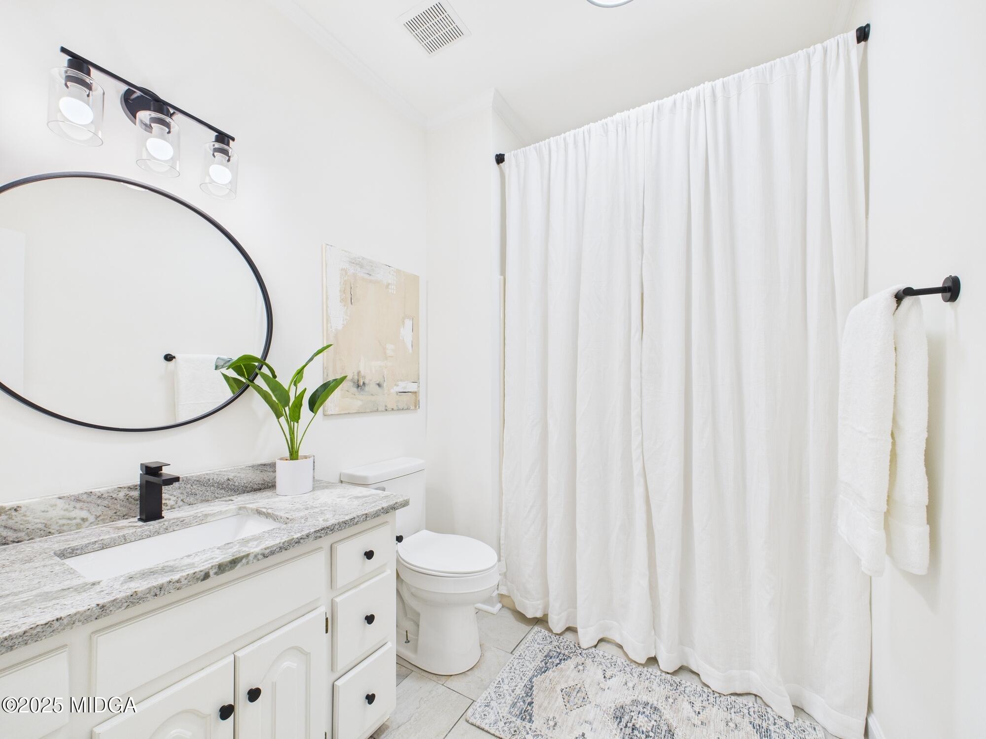 607 Chastain Place Macon, GA 31210 - Photo 27 of 63 a bathroom with a granite countertop sink and a mirror