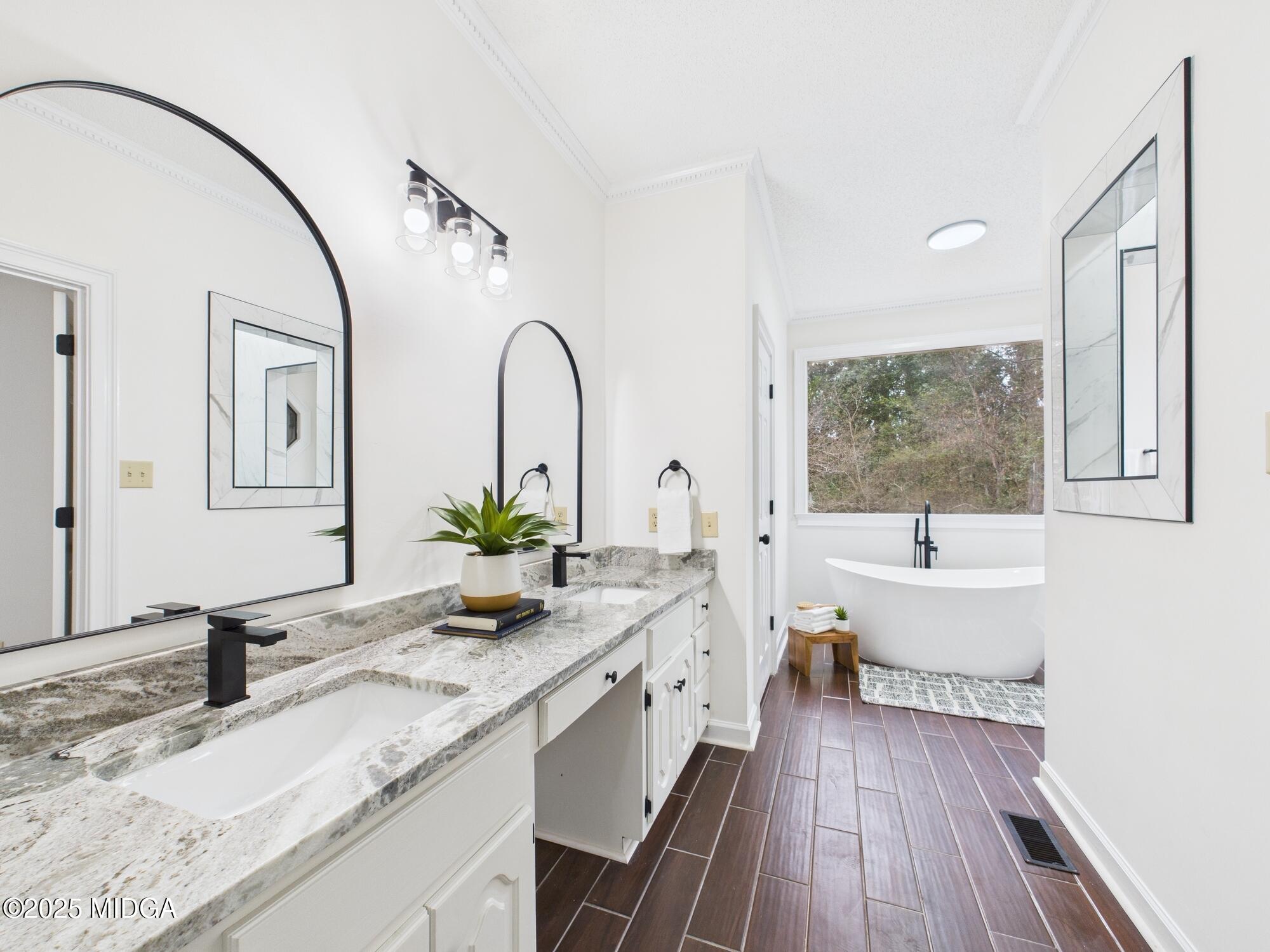 607 Chastain Place Macon, GA 31210 - Photo 47 of 63 a spacious bathroom with a granite countertop sink a mirror and bathtub