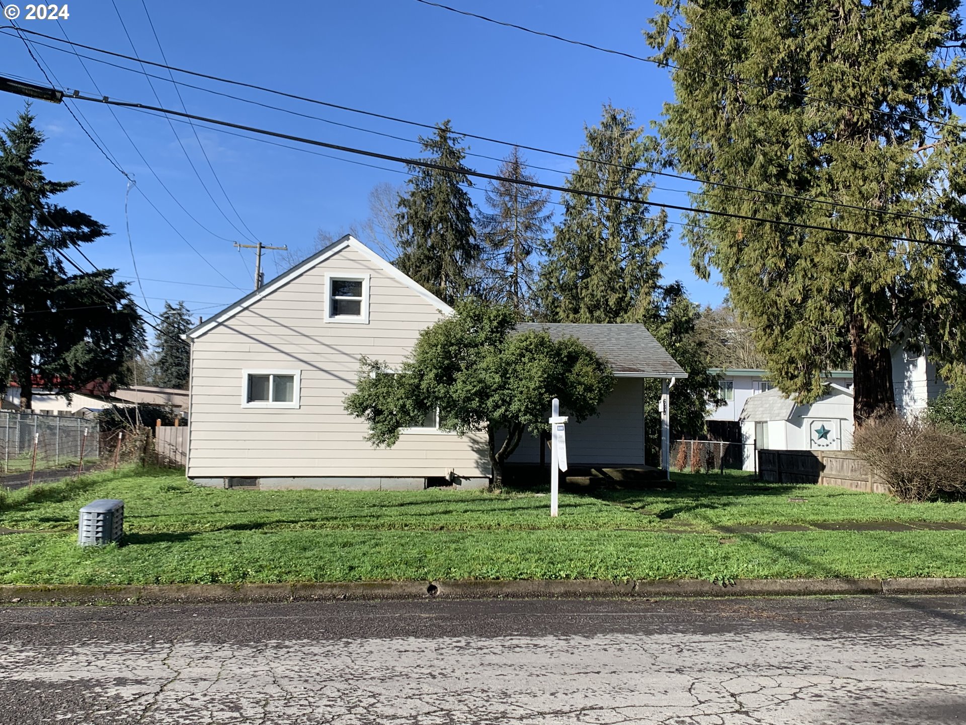 630 1st Street Springfield, OR 97477 - Photo 17 of 18 a front view of a house with a yard and garage