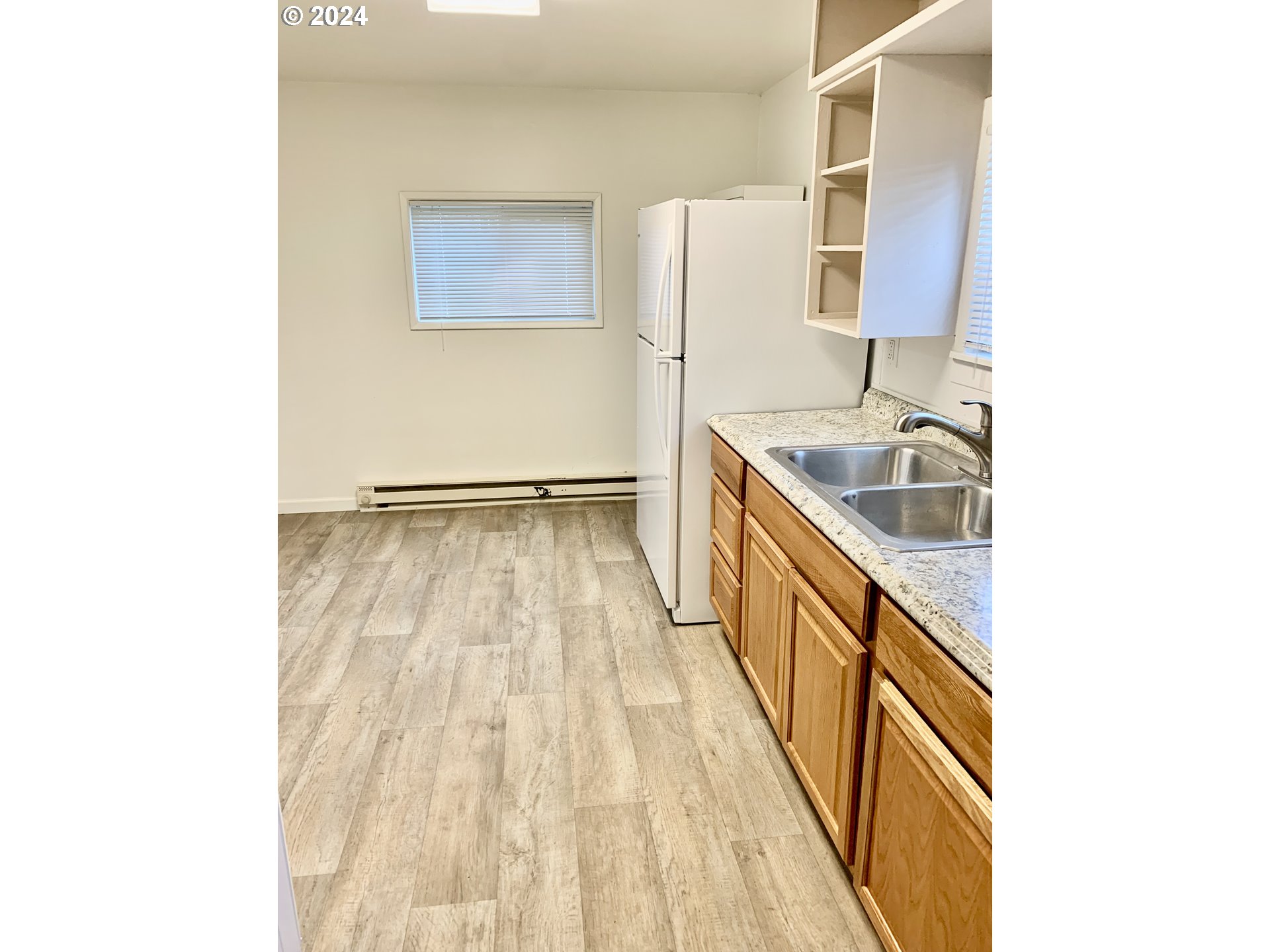 630 1st Street Springfield, OR 97477 - Photo 6 of 18 a kitchen with a sink a refrigerator and wooden floor