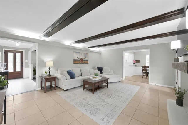 a living room with furniture and a dining table