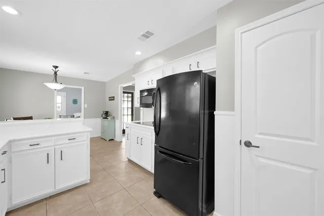 a kitchen with a refrigerator and a sink