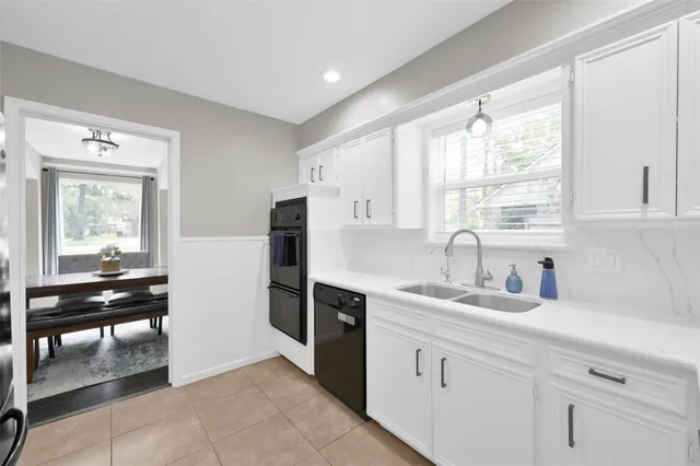 a kitchen with a sink cabinets and window