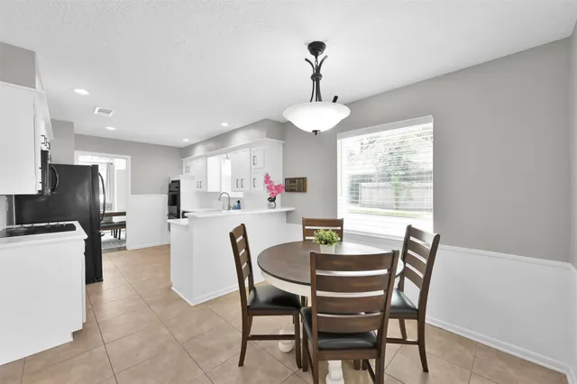 a view of a dining room with furniture and a chandelier