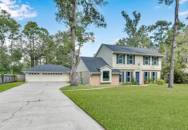 a front view of a house with a garden and yard