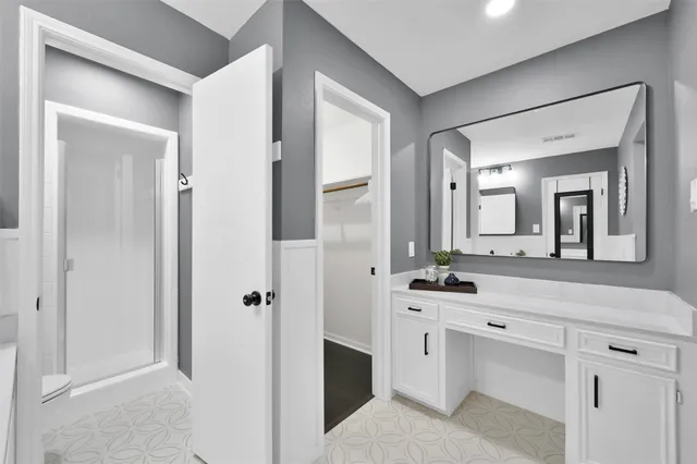 a bathroom with a double vanity sink mirror and