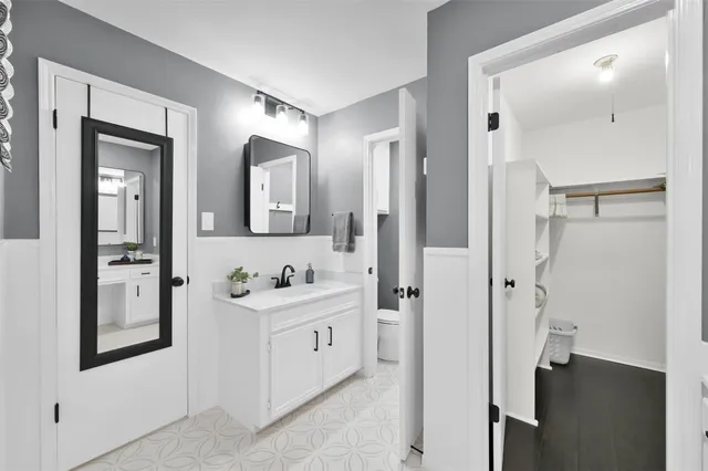 a bathroom with a double vanity sink mirror and shower