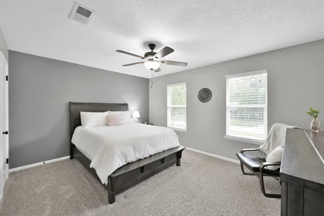 a bedroom with a bed and a chair