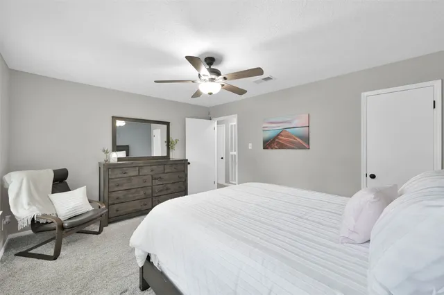 a bedroom with a bed and a chair