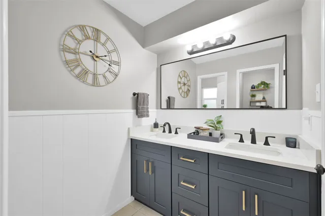 a bathroom with a double vanity sink and a mirror
