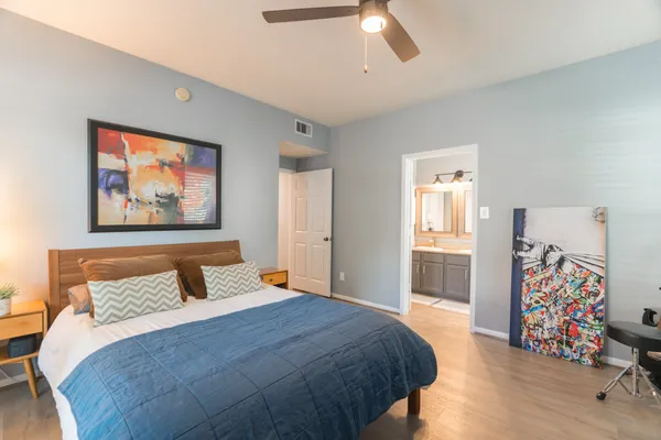 a bedroom with a bed and a chandelier