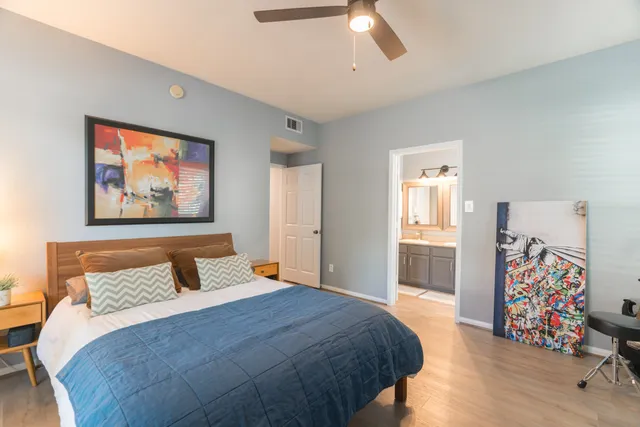 a bedroom with a bed and a chandelier