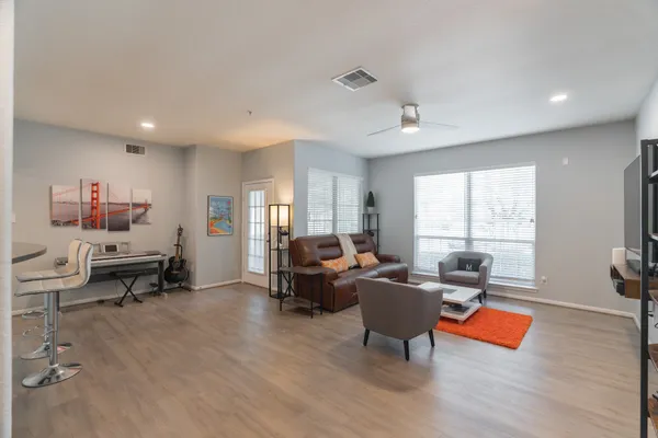 a living room with furniture and wooden floor