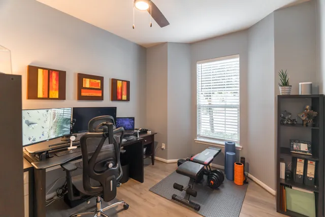 a view of a workspace with furniture and a window