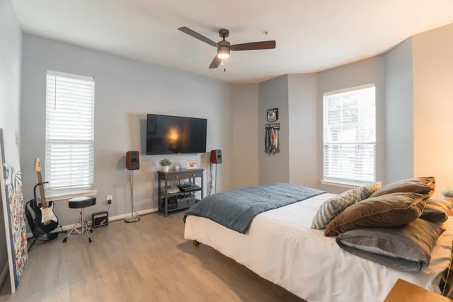 a bedroom with a bed furniture and a flat screen tv