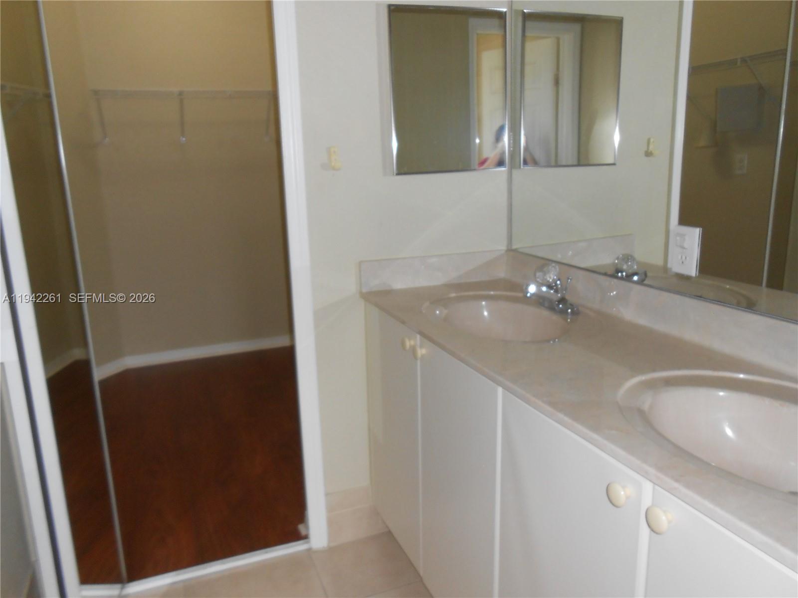 12470 Southwest 122nd Street Miami, FL 33186 - Photo 15 of 26 a bathroom with a sink and a mirror