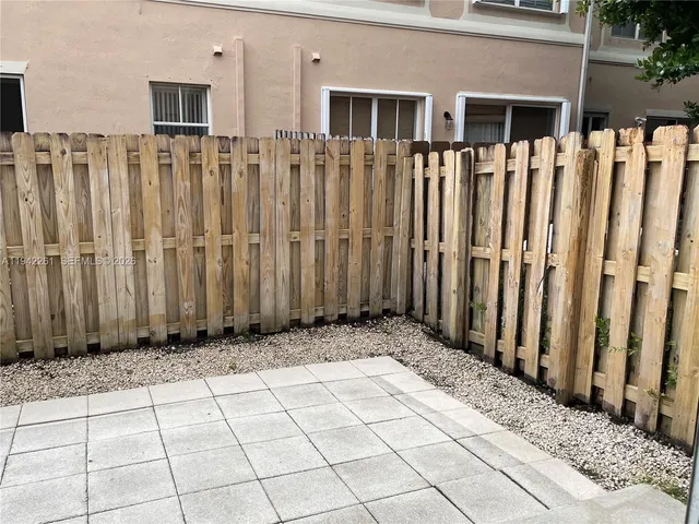 a view of a house with wooden fence