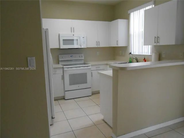 a kitchen with a sink cabinets and window
