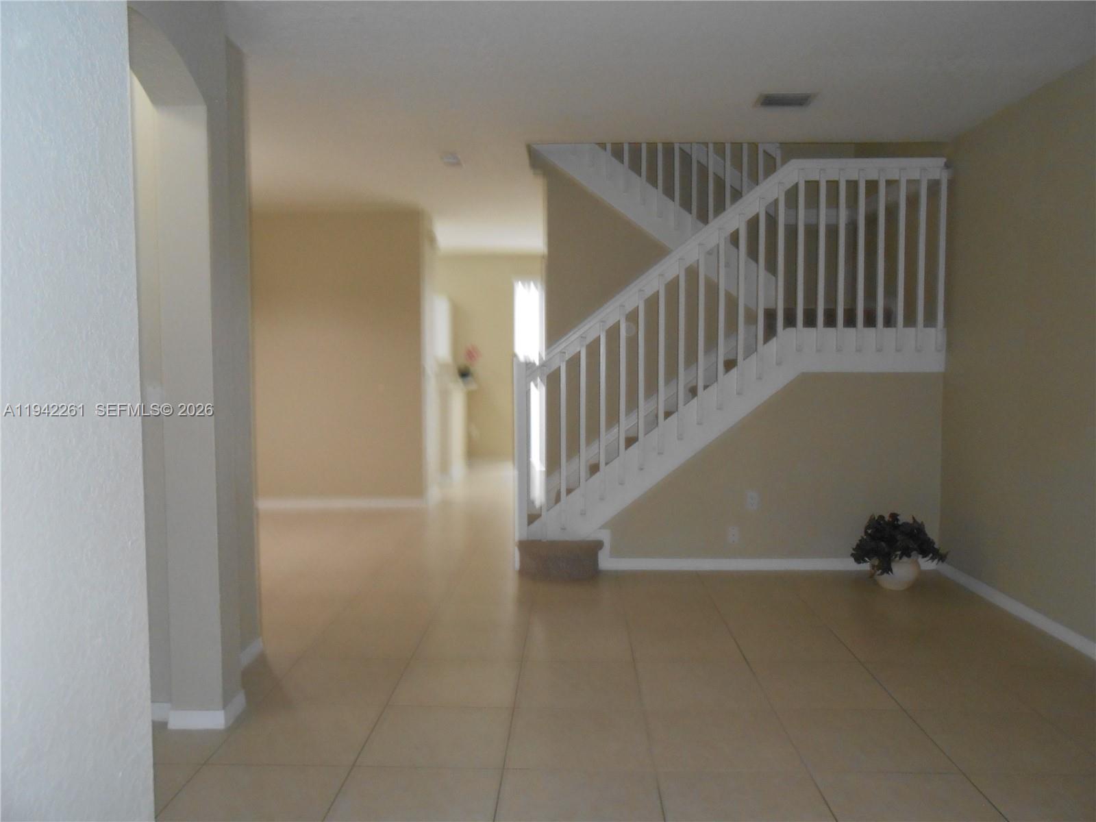 12470 Southwest 122nd Street Miami, FL 33186 - Photo 10 of 26 a view of entryway and hall with wooden floor