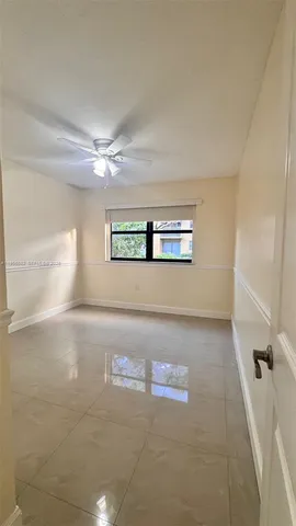 a view of a livingroom with a ceiling fan and window