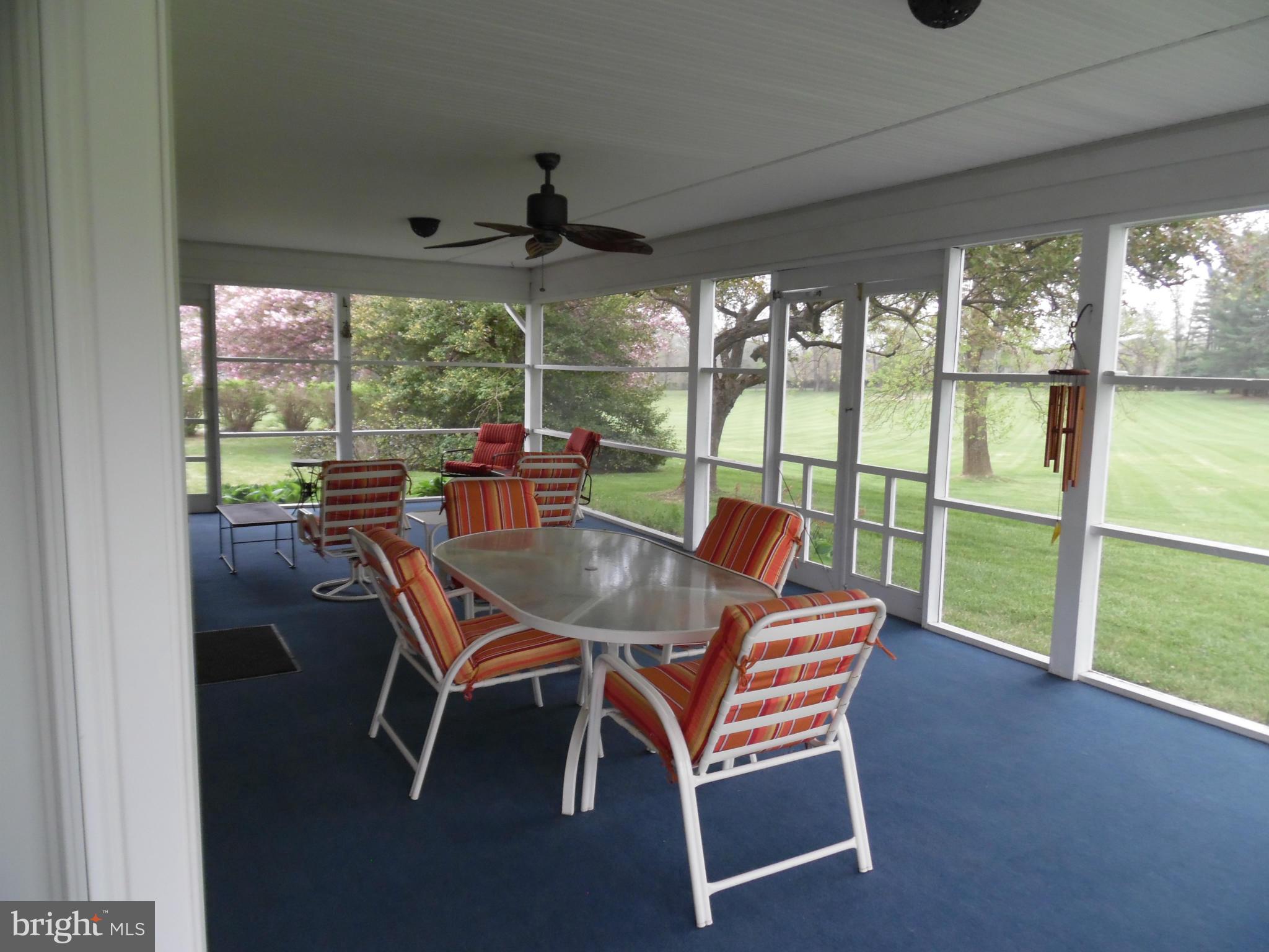 15031 Priceville Road Sparks, MD 21152 - Photo 4 of 4 a dining room with furniture a rug and a floor to ceiling window
