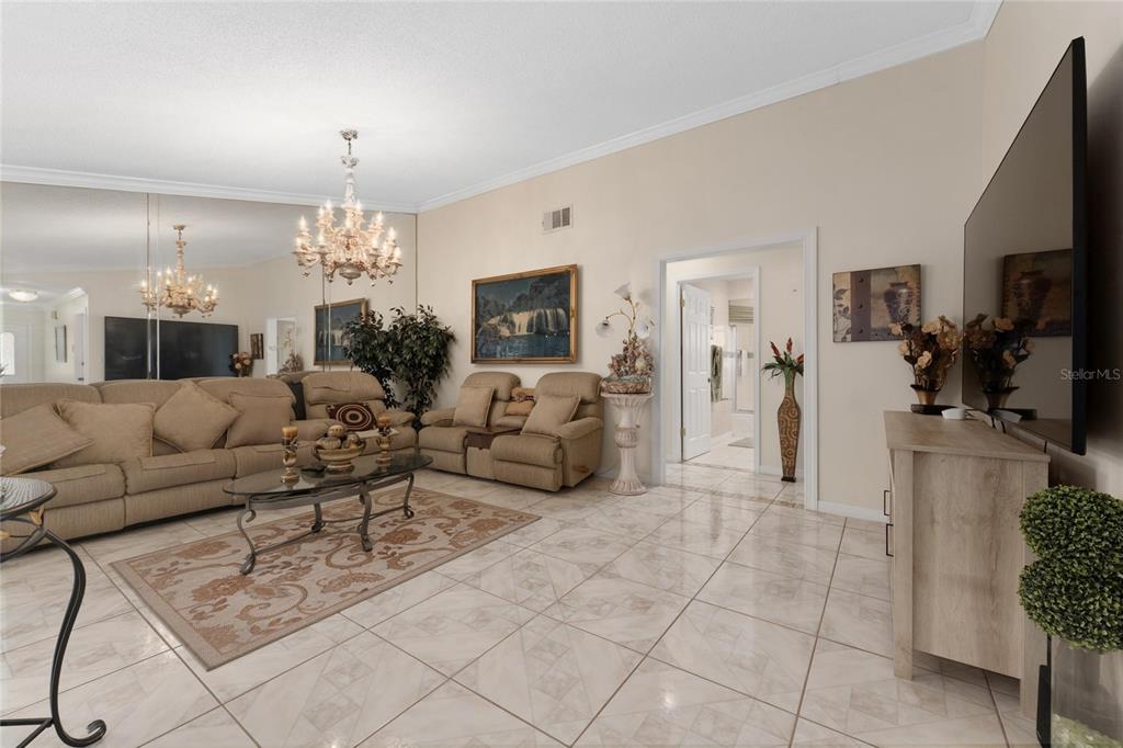 2779 Muscatello Street Orlando, FL 32837 - Photo 11 of 36 a living room with furniture a dining table and a chandelier