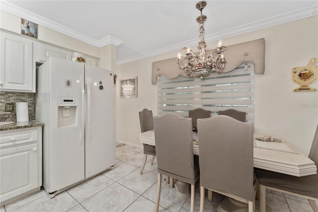 2779 Muscatello Street Orlando, FL 32837 - Photo 14 of 36 a dining room with furniture and window