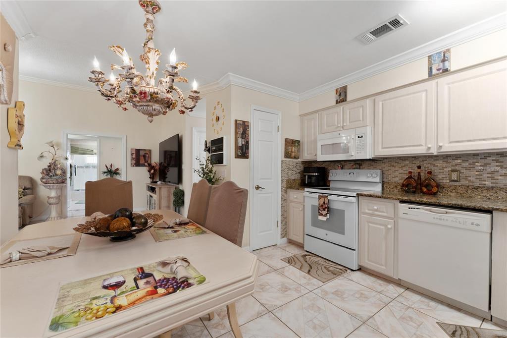 2779 Muscatello Street Orlando, FL 32837 - Photo 15 of 36 a kitchen with a refrigerator and cabinets