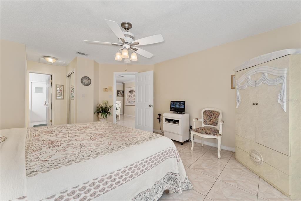 2779 Muscatello Street Orlando, FL 32837 - Photo 18 of 36 a spacious bedroom with a bed and a chandelier