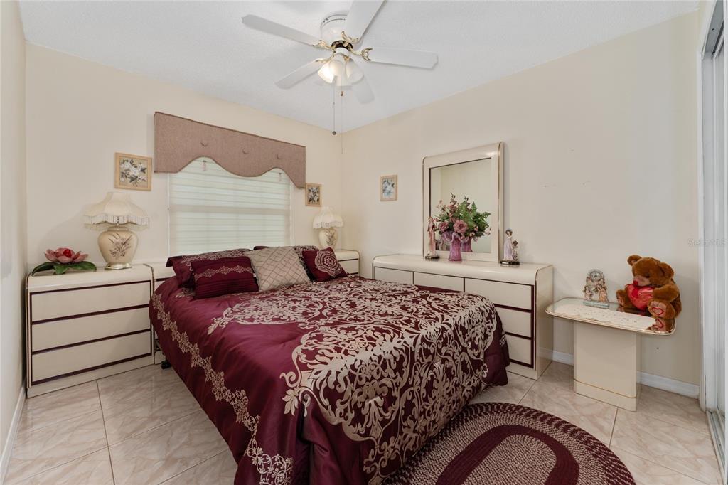 2779 Muscatello Street Orlando, FL 32837 - Photo 21 of 36 a bedroom with a bed and a chandelier