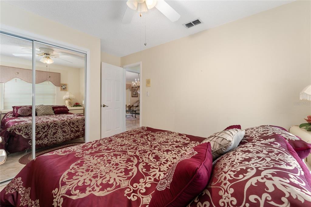 2779 Muscatello Street Orlando, FL 32837 - Photo 22 of 36 a bedroom with a large bed and a dresser