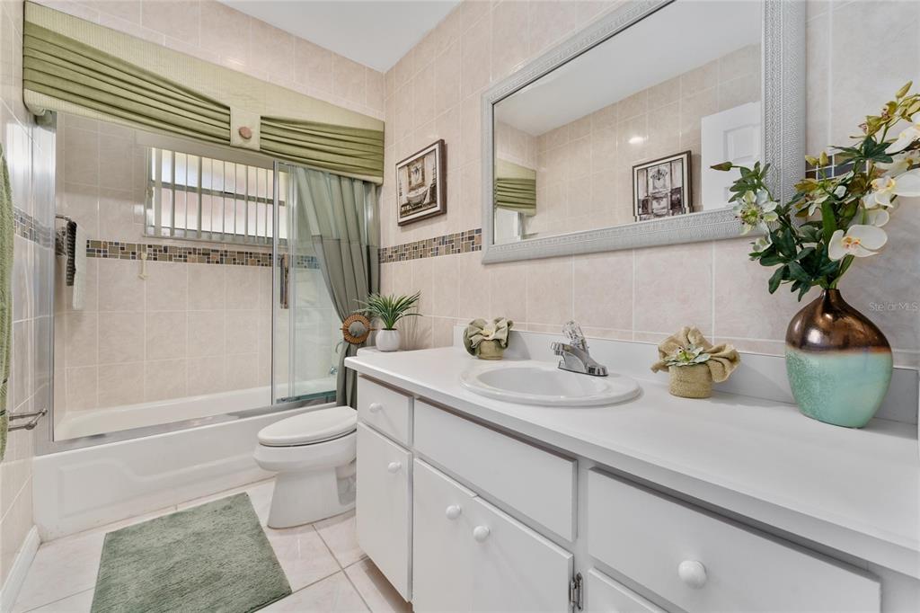 2779 Muscatello Street Orlando, FL 32837 - Photo 23 of 36 a bathroom with a granite countertop toilet sink and mirror
