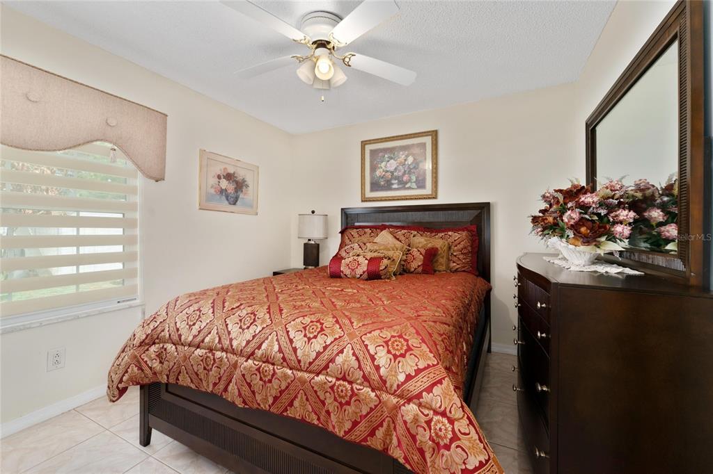 2779 Muscatello Street Orlando, FL 32837 - Photo 24 of 36 a bedroom with a bed and a chandelier