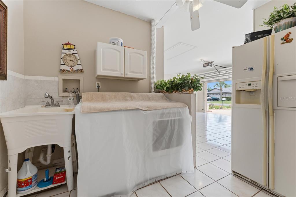 2779 Muscatello Street Orlando, FL 32837 - Photo 28 of 36 a utility room with cabinets washer and dryer