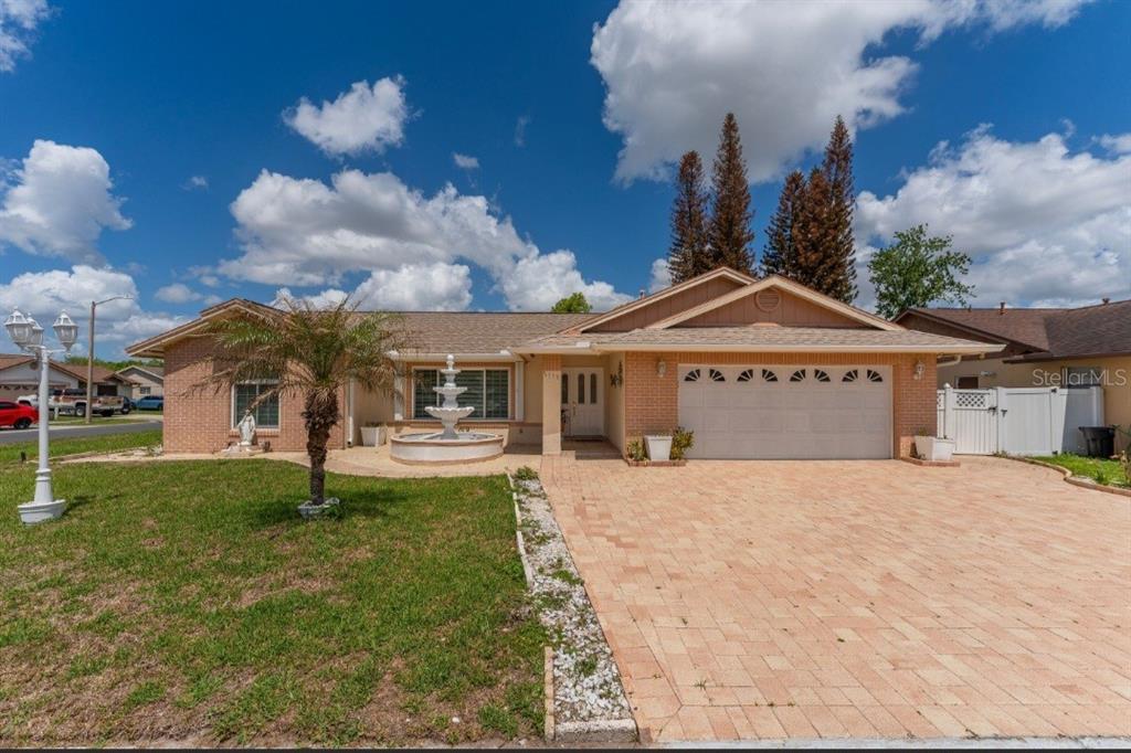 2779 Muscatello Street Orlando, FL 32837 - Photo 3 of 36 a front view of a house with a garden and yard