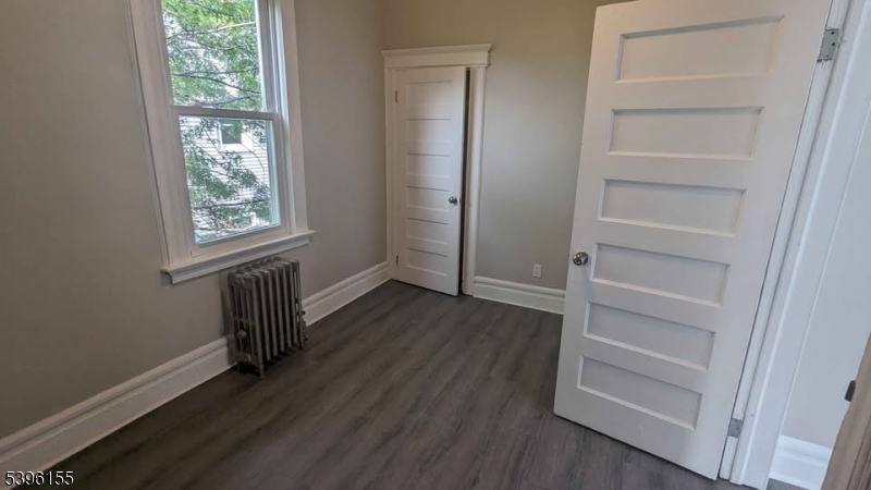 604 South 20th Street, Unit 2 Newark, NJ 07103 - Photo 4 of 10 a view of an empty room with a window and wooden floor