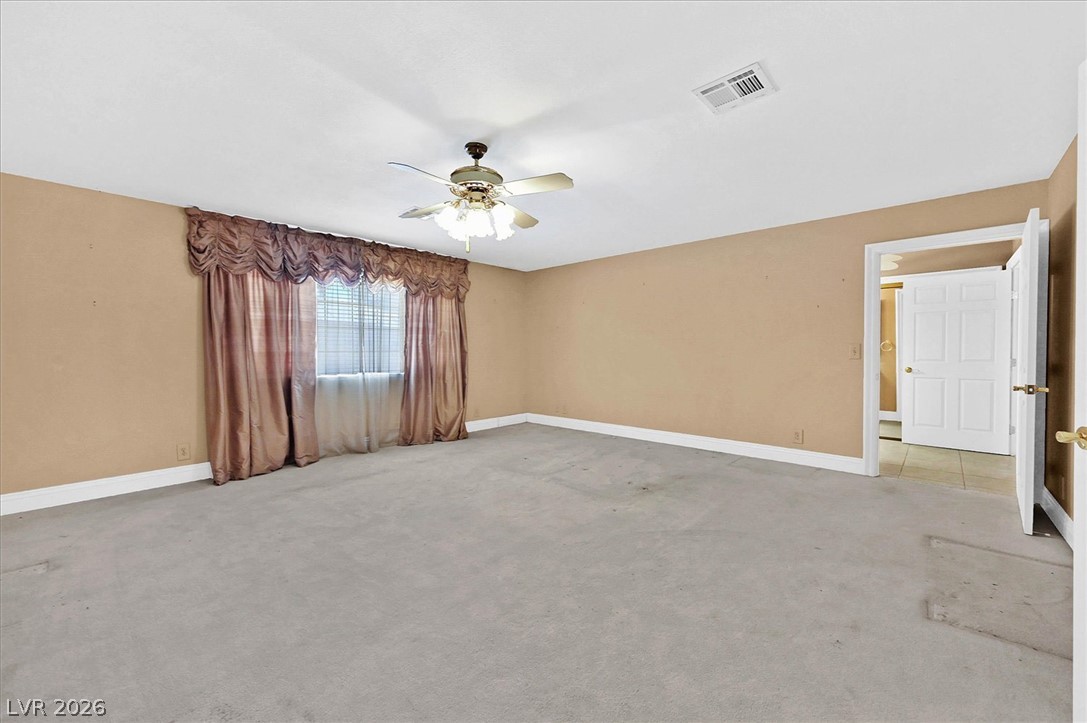 3618 Fieldcrest Road Las Vegas, NV 89121 - Photo 19 of 36 A spacious chamber awaits personalization, complete with soft carpeting and natural light filtering through window treatments.