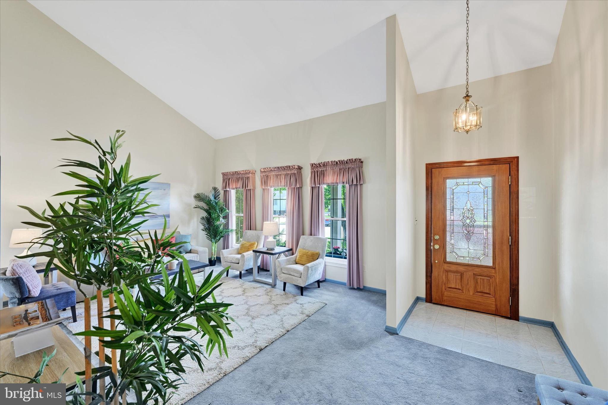 9115 Kilbride Road Baltimore, MD 21236 - Photo 5 of 61 a living room with furniture floor to ceiling window and potted plants