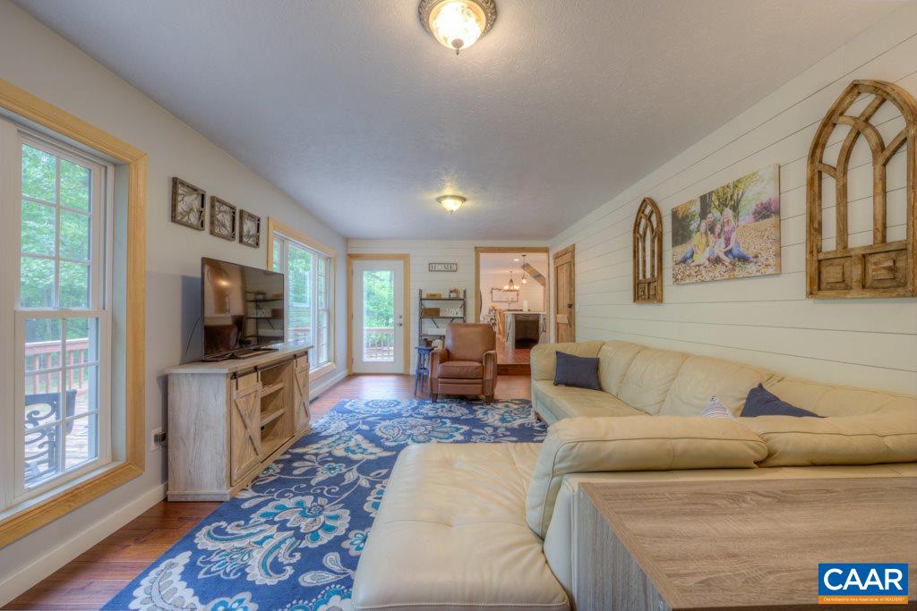 1877 Swift Run Road Ruckersville, VA 22968 - Photo 16 of 40 a living room with furniture and a flat screen tv