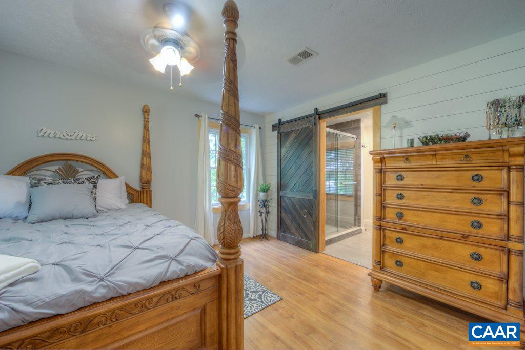 1877 Swift Run Road Ruckersville, VA 22968 - Photo 19 of 40 a bedroom with a bed and a dresser